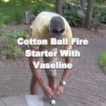 man lighting vaseline soaked cotton ball with ferro rod